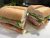 Two baguette submarine sandwiches stacked with lettuce, tomato, cheese and ham in Acadia National Park.