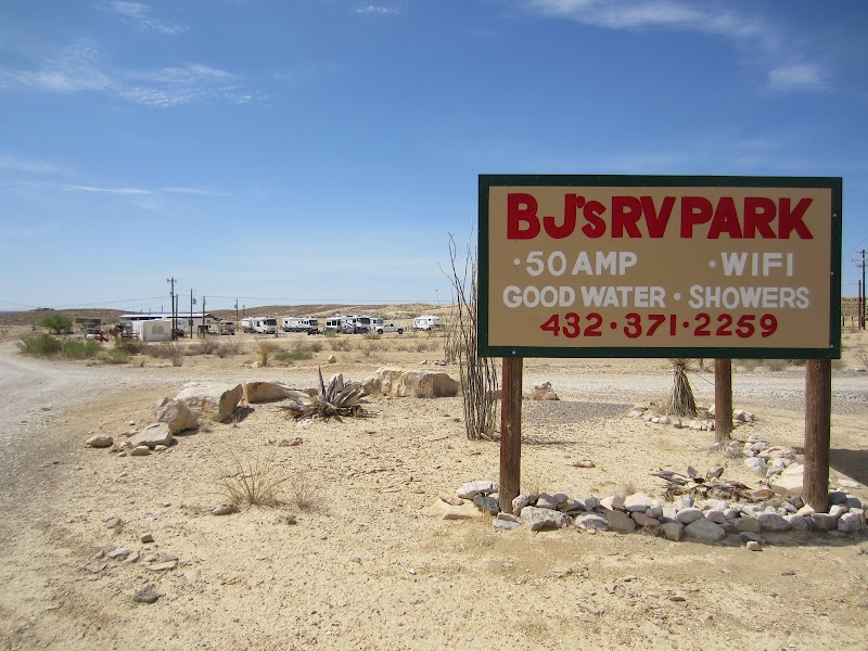 RV campground in Big Bend National Park with desert terrain and a line of campers in the distance.