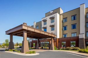 Kalispell hotel exterior with a covered porte-cochère and landscaped curb appeal near Glacier National Park.