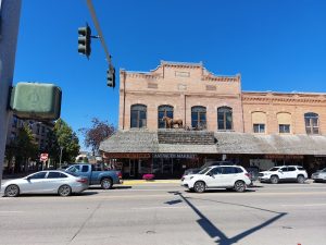 Historic hotel storefront on Main Street outside Glacier National Park, with brick architecture and a rooftop horse statue.