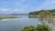 Trenton waterfront in Acadia National Park along a calm tidal inlet with pine fringe and blue sky.