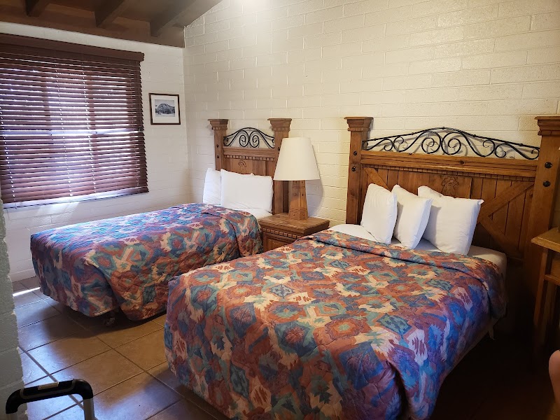 Guest room in Big Bend National Park with two queen beds and rustic wood furnishings.