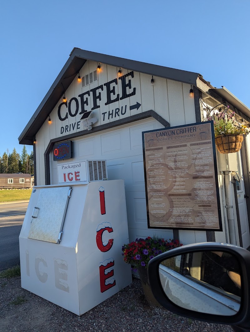 Drive-thru coffee stand at Glacier National Park in the Canyon area, with an ice freezer and warm string lights.
