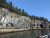 Winter Harbor cliffs along Acadia National Park show rugged granite shoreline with pine trees under a clear blue sky.