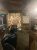 Interior view inside a rustic Yellowstone bar area featuring a large colorful spinning wheel behind the lounge seating.