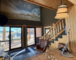 Exterior view of a brick hotel building with a parking area and street access