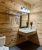 Bathroom vanity with towel shelf and mirror inside a rustic lodge room at Badlands National Park.