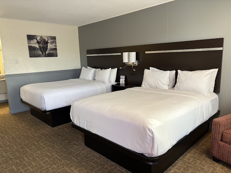Long hotel corridor with carpet runners and wall sconces