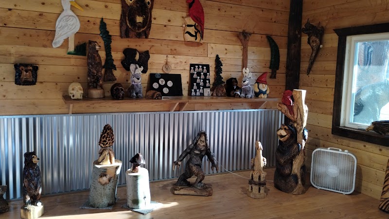 Interior view showing rustic wood shelves and chainsaw art on display