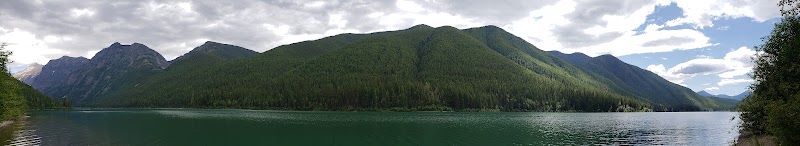 Harrison Lake panorama along Glacier National Park's Harrison Lake with forested mountains and a calm green lake.