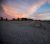 Sunset over a desert campground at Big Bend National Park, with gravel lots and distant mountains.