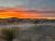 Sunset over a desert campground with RVs at RoadRunner Travelers RV Park in Big Bend National Park.