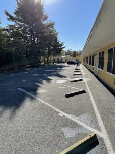 High Seas Motel parking lot beside a yellow lodging building in Acadia National Park