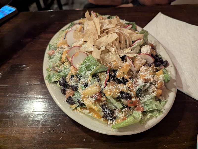 Colorful mixed salad with greens, radishes, black beans, and crispy tortilla strips served in Big Bend National Park.