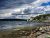 Southwest Harbor coastline in Acadia National Park, with boats anchored offshore and rocky shore.