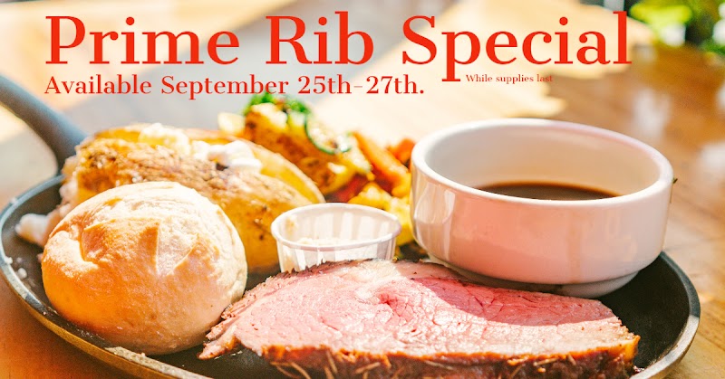 Prime rib on a skillet with a roll, small sauce cup, and vegetables at Arches National Park.