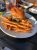Cheeseburger with lettuce and cheese and a side of fries on a plate at a casual outdoor dining table in Acadia National Park.