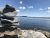 Bar Harbor Shore Path along a rocky shoreline with calm blue water in Acadia National Park.