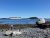 Bar Harbor Shore Path along Acadia National Park’s rocky shoreline, with a distant cruise ship on the Atlantic.