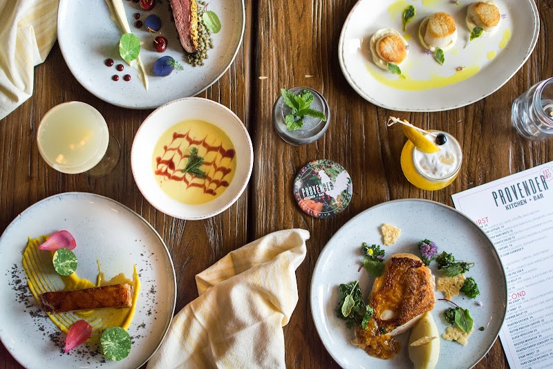 Dining spread at a restaurant in Acadia National Park showcasing varied plates and stylized presentation.