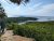 Hiker at a rocky Cadillac Mountain overlook in Acadia National Park gazes over Frenchman Bay.