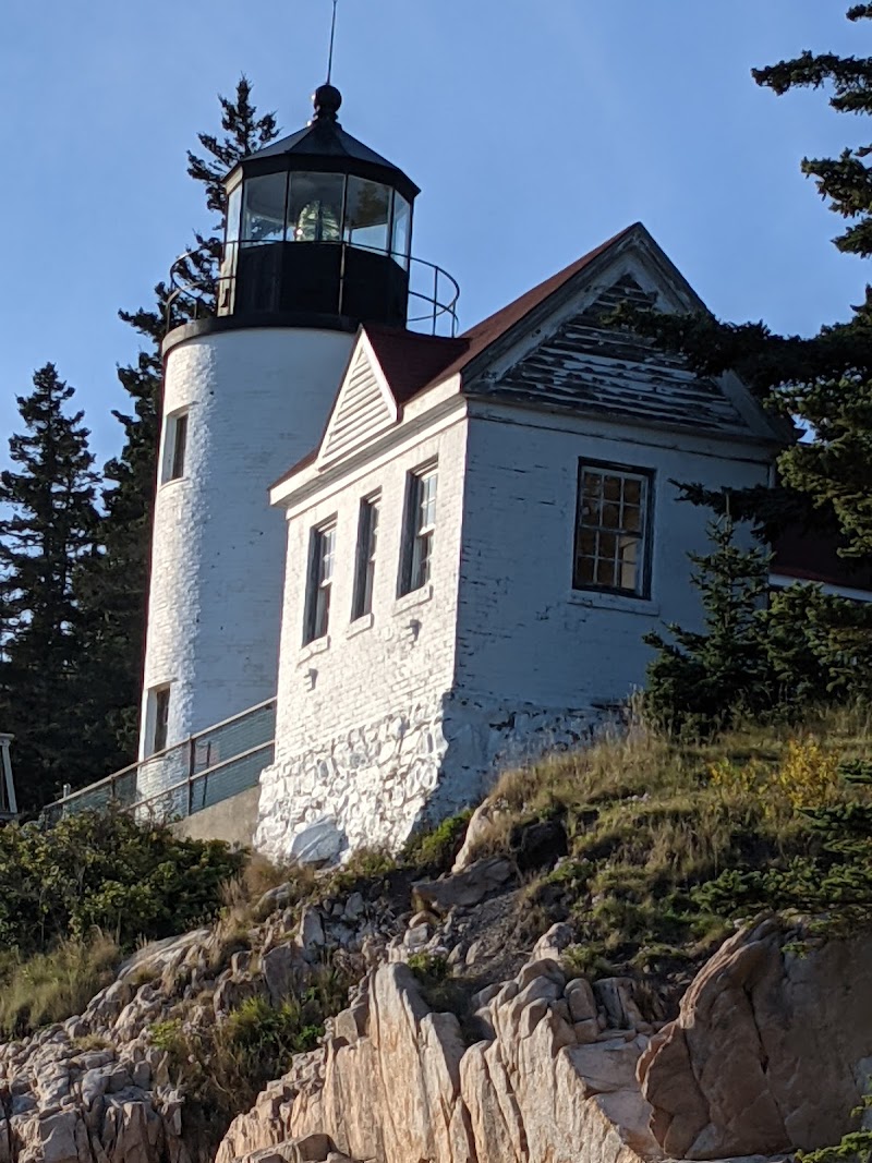Bass Harbor Head Light on a rocky coastline, a white lighthouse with lantern room overlooking the sea in Acadia National Park