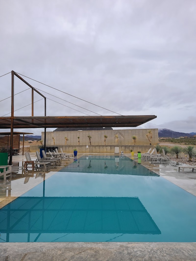 Pool at lodging near Terlingua with lounge chairs and a shaded deck in Big Bend National Park.