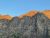 Sunlit granite peaks over a campground near Lincoln Lake in Glacier National Park.