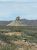 West Entrance of Big Bend National Park featuring a rugged, isolated rock formation rising from desert terrain.