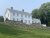 Castine house on a grassy hill with a stone terrace in Acadia National Park, Maine.