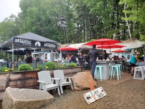 Outdoor dining area with umbrellas at a lobster-themed eatery in Acadia National Park.