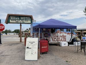 Exterior storefront with bold signage and bacon-themed decor