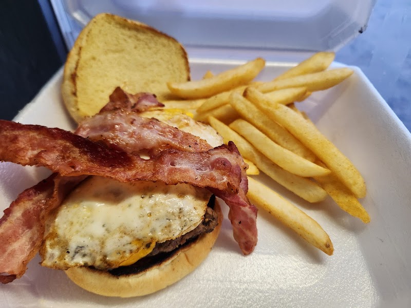 Cozy dining room featuring warm lighting, reclaimed wood, and booth seating