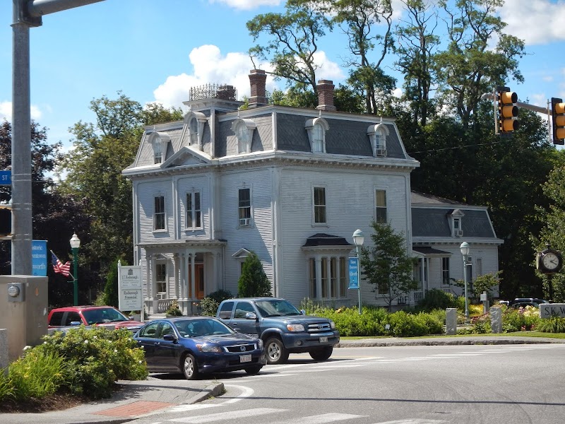 Ellsworth townhouse-style home near Acadia National Park sits beside a busy street with traffic lights.