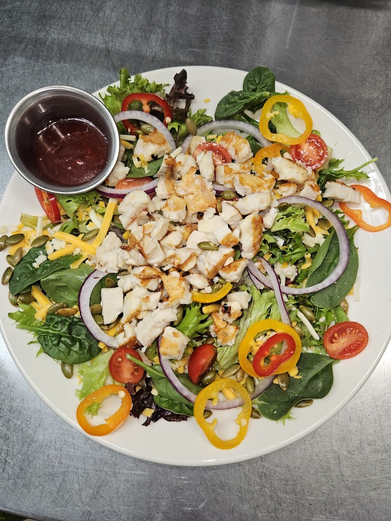 Grilled chicken salad over mixed greens with peppers and onions at a cafe in Acadia National Park.
