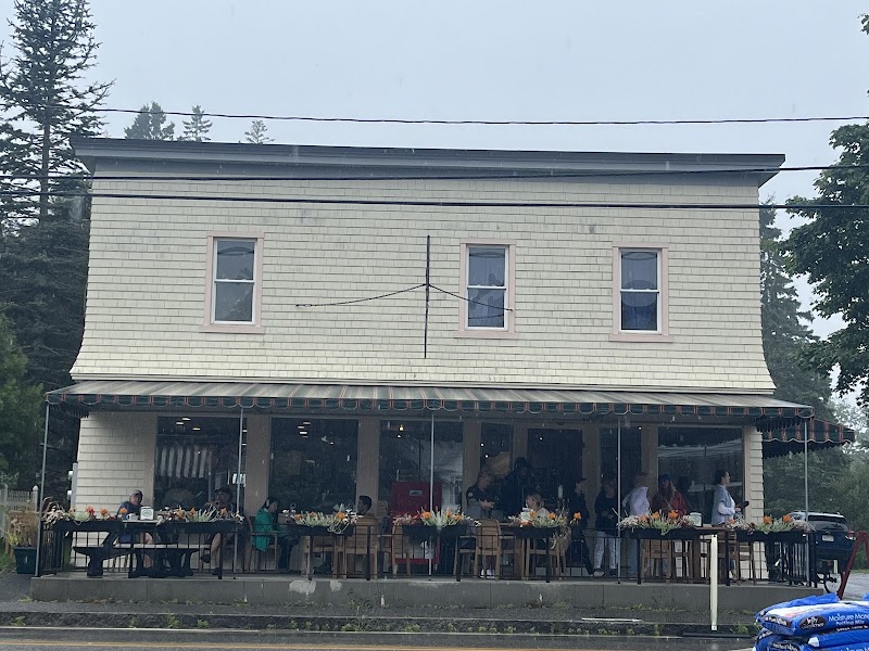Outdoor dining at a cafe in Acadia National Park, with patrons seated under a shaded awning.