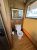 Cozy cabin bathroom inside Acadia National Park lodging, with wood paneling and a standard toilet.