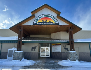 Gift shop entrance in Cody with Yellowstone signage, winter snow around the doorway in Yellowstone National Park.