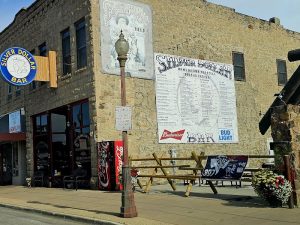 Stone-front historic bar facade along a small town street in Yellowstone National Park.
