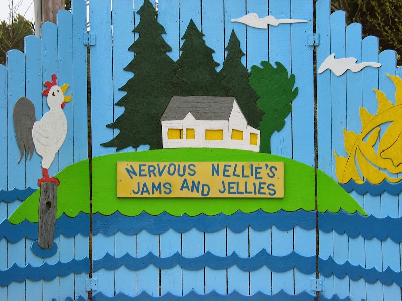 Nervous Nellie's Jams and Jellies gift shop facade on a colorful painted fence in Acadia National Park.