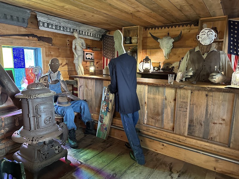 Gift shop interior in Acadia National Park with vintage mannequins, American flags, and rustic wood shelves.