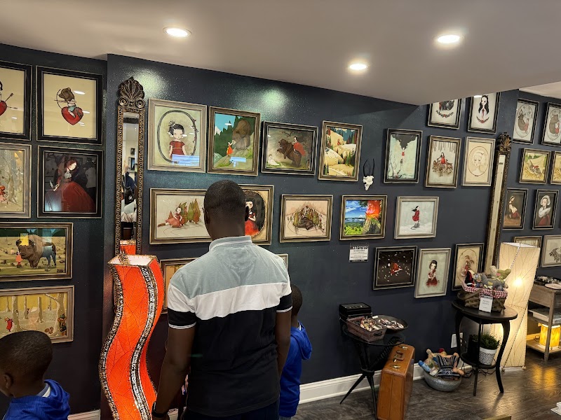 Interior view of a gift shop in Acadia National Park, walls lined with framed artwork.