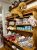 Wood shelving in Acadia National Park gift shop with a large plush dog, printed pillows, blue cat mugs, and assorted souvenirs.