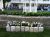 Exterior view of a stone flower bed with lush greenery in front of a lodging building in Acadia National Park.