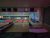 Candlepin bowling alley interior in Acadia National Park, with glowing lanes, neon lighting, and a digital scoring screen above the pins.