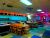 Interior of a candlepin bowling alley near Ellsworth, in Acadia National Park, with glowing neon lights and arcade games.