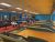 Candlepin bowling alley interior in Acadia National Park with long lanes and blue seating.