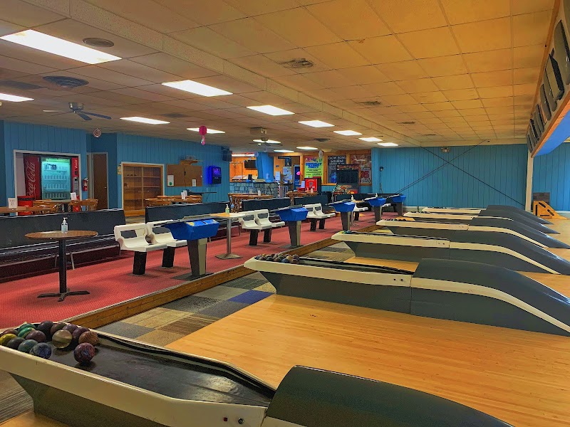 Candlepin bowling alley interior in Acadia National Park with long lanes and blue seating.
