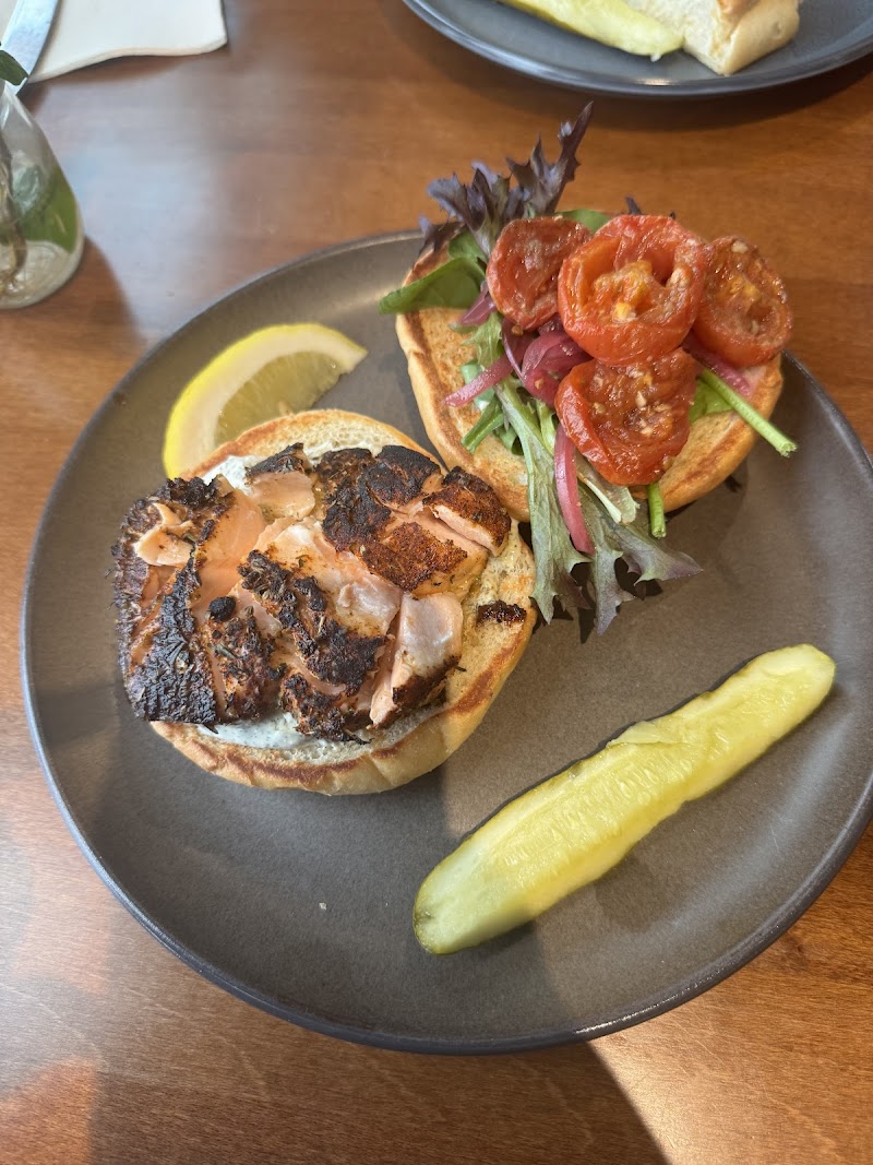 Lobster roll and greens on a bun with pickles and lemon at Peekytoe Provisions, Acadia National Park, Bar Harbor.