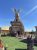 Rustic deer-shaped restaurant building covered in wooden shingles with large antlers and carved figures in Badlands National Park.